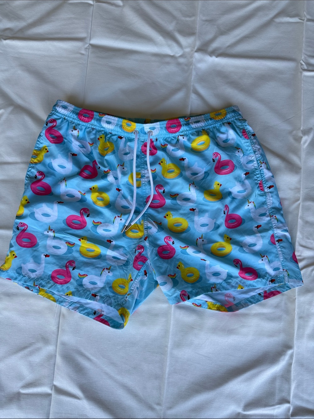 Light Blue Swim Trunks with Pink, Yellow & White Inflatable Float Print